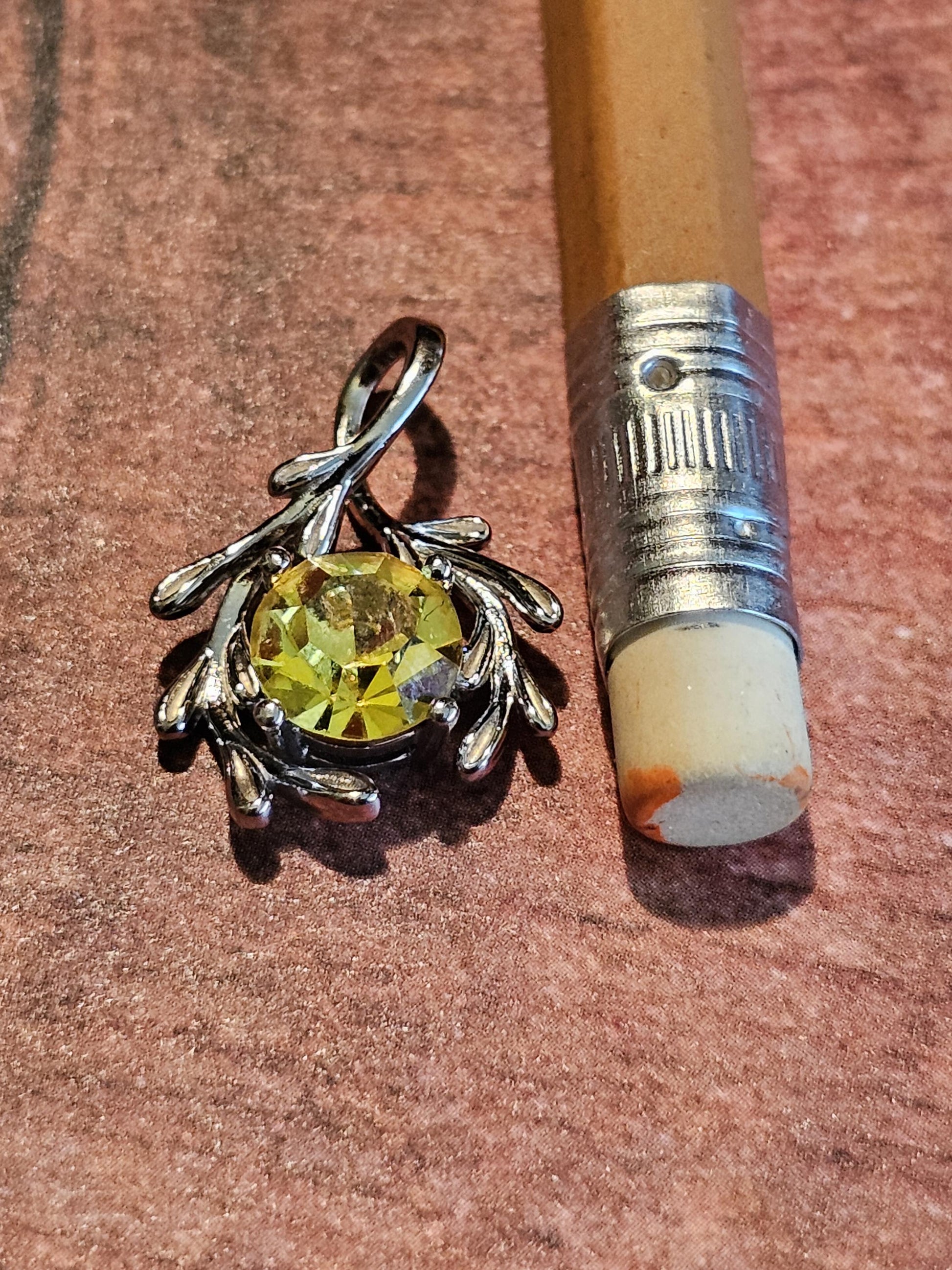 Cadmium Glass Pendant in new Sterling Silver with a vintage Round cut 7 mm Cadmium glass stone that glows under black / UV light