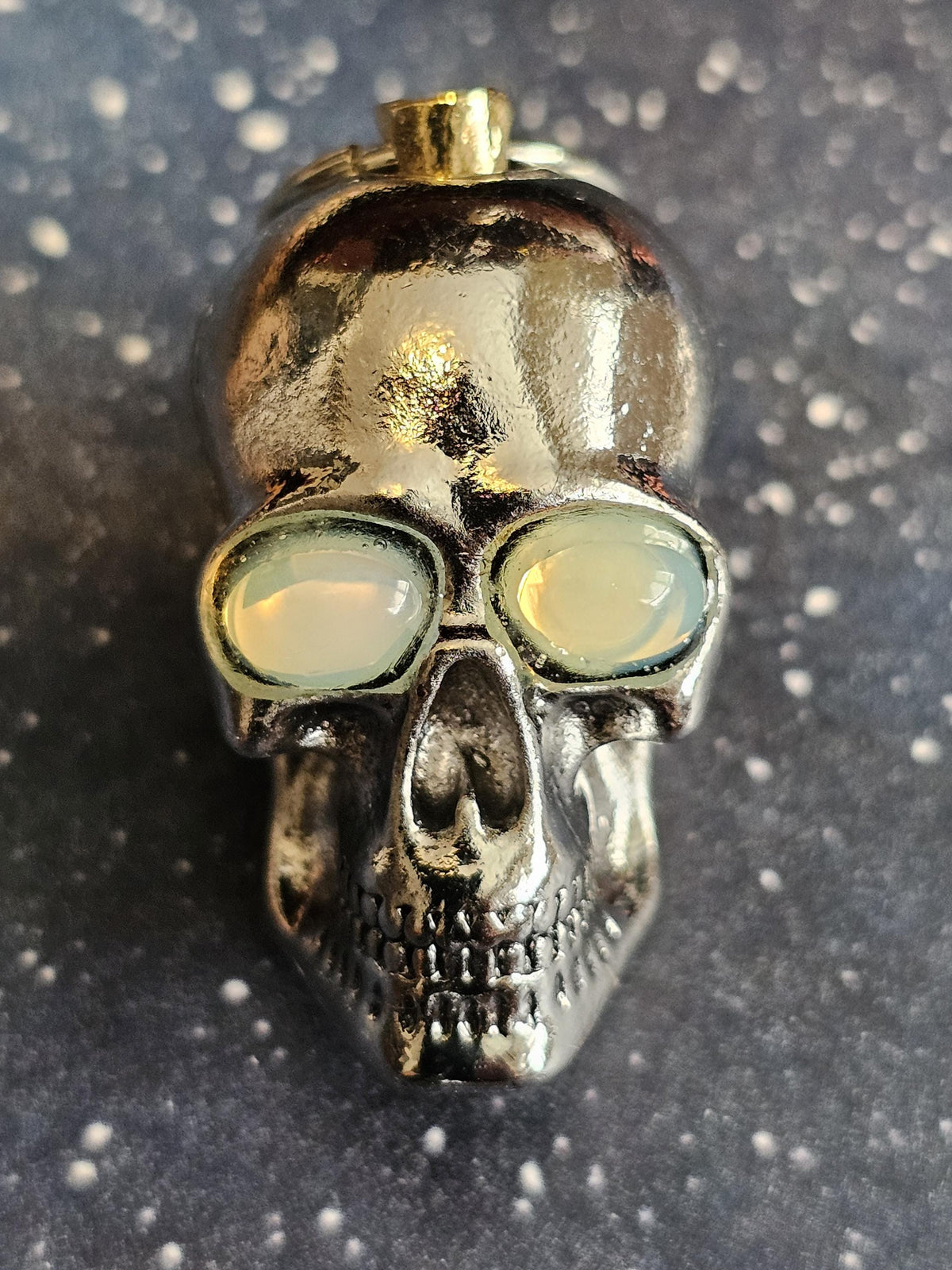 Uranium glass Skull Keychain this 1.25-in tall zinc alloy skull contains two White vintage 8x6 oval vintage Uranium glass stones in its eyes